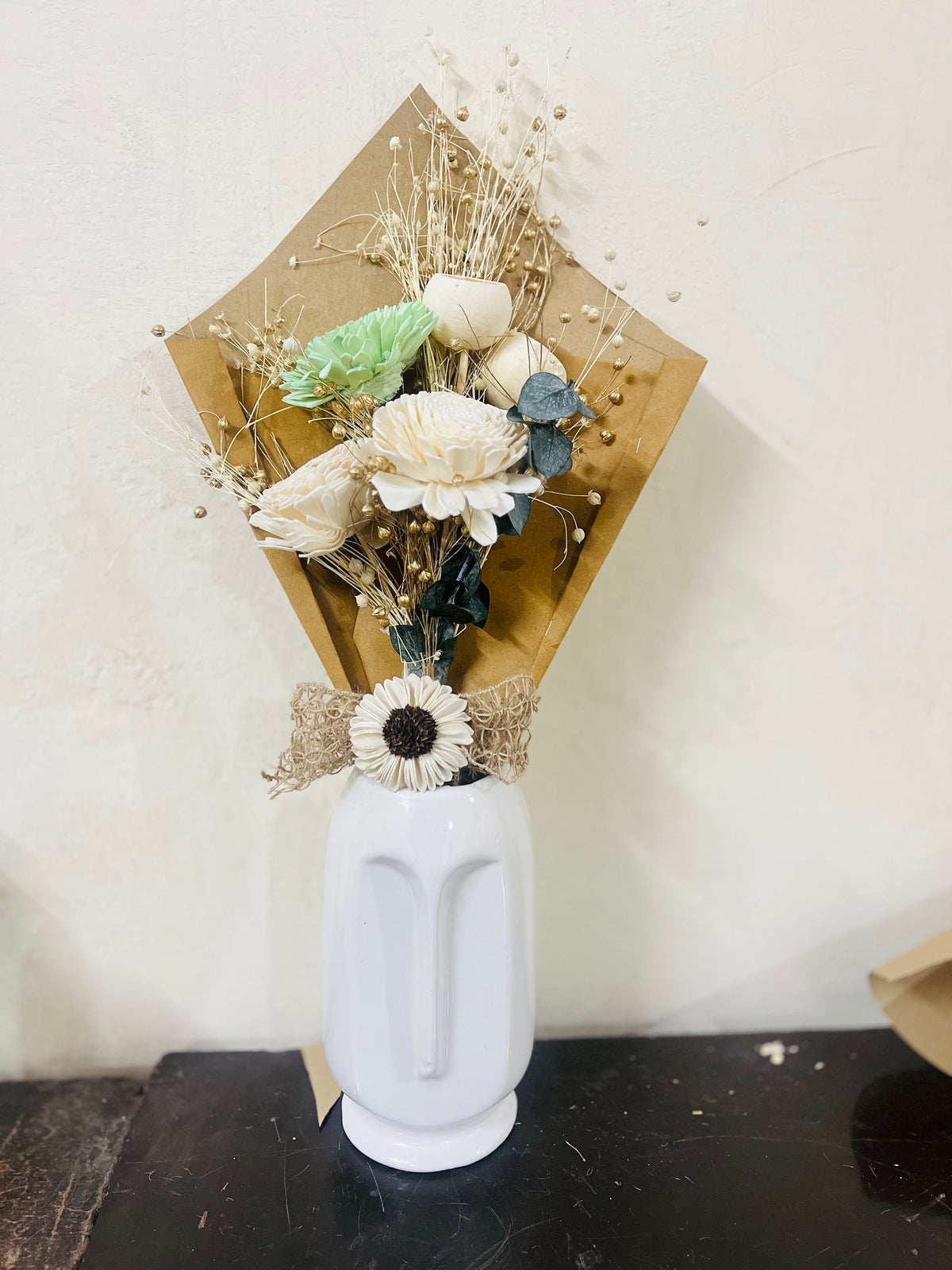 Cup bouquet with face vase